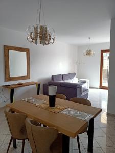 a living room with a table and a couch at CasaMare Luxury Siderno in Siderno Marina