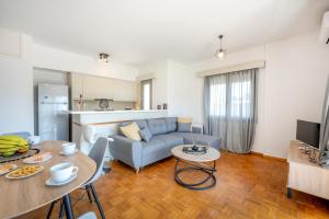 a living room with a couch and a table at City Calm House in Platánion