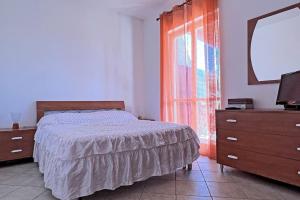 a bedroom with a bed and a dresser and a mirror at Villa Belvedere - Baia azzurra in Torre San Limato