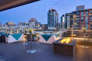 a rooftop deck with a fire pit and a city skyline at Hotel Indigo San Diego - Gaslamp Quarter, an IHG Hotel in San Diego