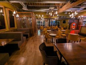 a restaurant with tables and chairs in a room at Premium Mobilhome Grimaud in Grimaud