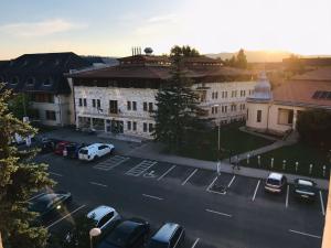 an aerial view of a parking lot in front of a building at CENTRUM Apartman in Sárospatak