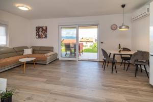 a living room with a couch and a table at Apartmani Krtica 1 in Vrbnik