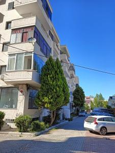 a white car parked in front of a building at Elezi House in Durrës +6 photos