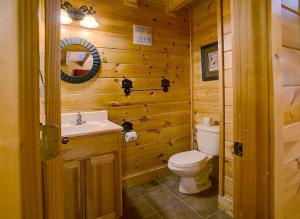 a bathroom with a toilet and a sink at Belvedere by Eden Crest in Sevierville +39 photos