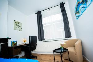 a living room with a chair and a window at Chambre R1 avec salle de bain privée in Liège