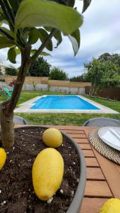 a table with a tree and a pool at O Lar de Laura in Vigo