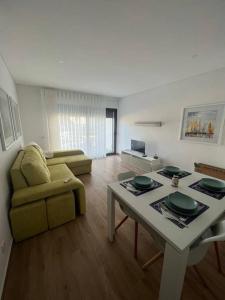 a living room with a table and a couch at Stay at Praia da Rocha! in Portimão