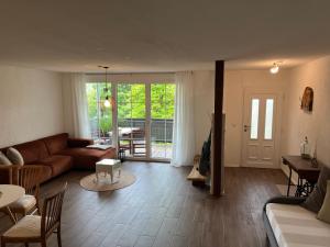 a living room with a couch and a table at Apartment Kastanienblick in Tettnang