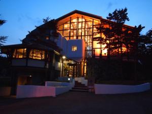 a large building with a lot of windows at night at The Phat House in Hakuba