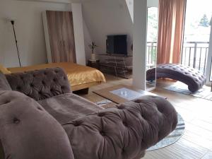 a living room with a couch and a bed at Aluna 3 in Višegrad