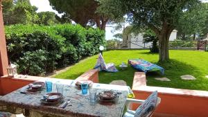 a table with plates of food on it in a yard at Villa ValePina in Villasimius
