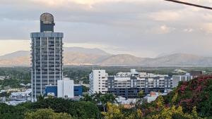 a view of a city with a tall building at Classic Queenslander Suite in Townsville +15 photos