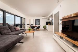 a living room with a couch and a table at Villa Aurea Apartments de Luxe Malinska Luxus Apartments mit beheiztem Pool Insel Krk in Malinska