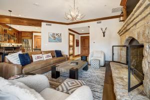 salon z kanapą i kominkiem w obiekcie Ski-in Ski-out 1 BdrDen in exclusive Horizon Pass condo w mieście Avon