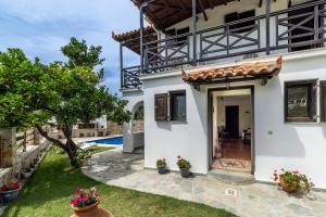 a villa with a pool and a yard at Alexandra Pool Villa - Comfort & Views Near Town in Skopelos Town