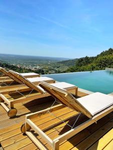 a deck with lounge chairs and a swimming pool at Quinta Altamira in Portalegre