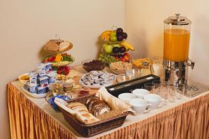 a table topped with lots of different types of food at Centrooms House in Budapest