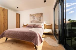 a bedroom with a bed and a painting on the wall at Villa Aurea Apartments de Luxe Malinska Luxus Apartments mit beheiztem Pool Insel Krk in Malinska +40 photos