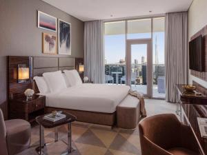 Un ou plusieurs lits dans un hébergement de l'établissement Hyde Hotel Dubai