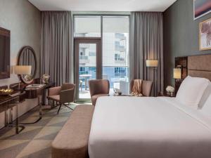 Un ou plusieurs lits dans un hébergement de l'établissement Hyde Hotel Dubai