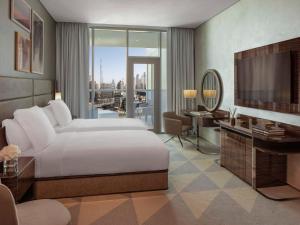 Un ou plusieurs lits dans un hébergement de l'établissement Hyde Hotel Dubai
