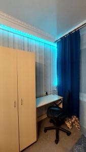 an office with a desk and a chair and blue lights at 2 bedroom apartment metro Vasilkovskaya in Kyiv