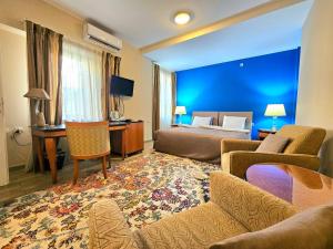 a hotel room with a bed and a living room at Male stepenice in Belgrade