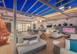 a living room with white furniture and a table at Cosmopolitan Hollywood Home DTLA view Parking - 10mins to Universal Studios in Los Angeles