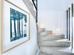 a framed picture on a wall next to a stairway at LA VILLA CAP COZ - 3 Chambres - Plage à 800 m in Fouesnant