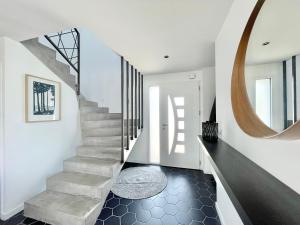 a staircase in a house with a round mirror at LA VILLA CAP COZ - 3 Chambres - Plage à 800 m in Fouesnant +51 photos