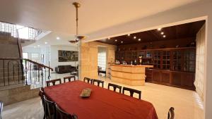 a dining room with a table and a bar at Rora in Caracas