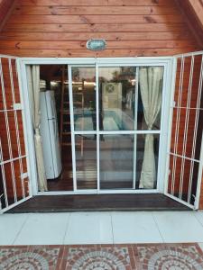 an open sliding glass door in a house at Tiny House - Los Cedros in Tartagal