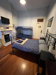 a bedroom with a bed and a fireplace at Newtown Backpackers in Sydney