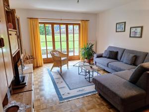 a living room with a couch and a table at Ferienwohnung Hinterstoißer in Berchtesgaden