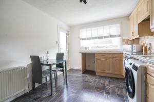 リビングストンにあるLivingston 4 Bed + Car Spaceのキッチンにテーブルと椅子がある