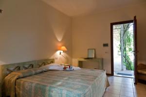 a bedroom with a bed with a table on it at Hotel La Conchiglia in Fregene