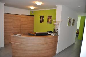 a lobby with a reception counter and green walls at Appartement Sporthütte Fiegl in Sölden