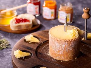 a cake sitting on a wooden cutting board with butter at Hotel Gracery Sapporo in Sapporo