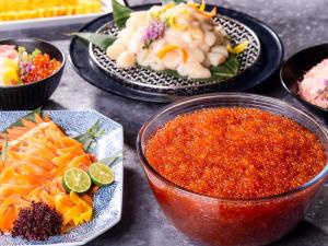 a table with plates of food and a bowl of sauce at Hotel Gracery Sapporo in Sapporo