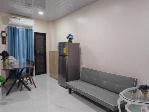 a living room with a couch and a table at Quirino hub (404) in Davao City +5 photos