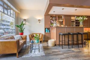 a living room with a couch and a bar at Hotel Carlton in Ghent