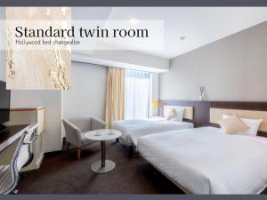 a hotel room with two beds and a tv at Hotel Gracery Sapporo in Sapporo