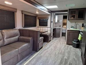 an rv living room with a couch and a kitchen at Sunset Trailer Park RV # 4 in El Suazal