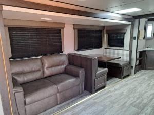 a living room with a couch and a table at Sunset Trailer Park RV # 4 in El Suazal