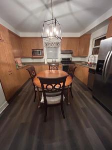 a kitchen with a table and chairs and a refrigerator at Walk on the riverside in Montreal