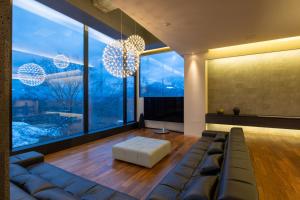 a living room with a couch and large windows at Nero in Kutchan