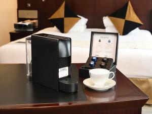 a desk with a computer and a cup of coffee at Royal Park Hotel in Tokyo