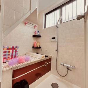 a bathroom with a shower and a sink at 花乃郷 西池袋 in Tokyo