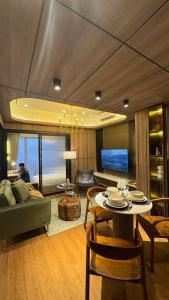 a living room with a table and a couch at Earthy Modern 2 Bedrooms Apt in Sleman